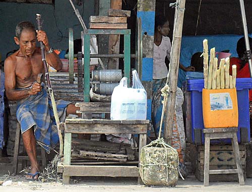 'A Burmese Man, Paring Sugar Cane' by Asienreisender